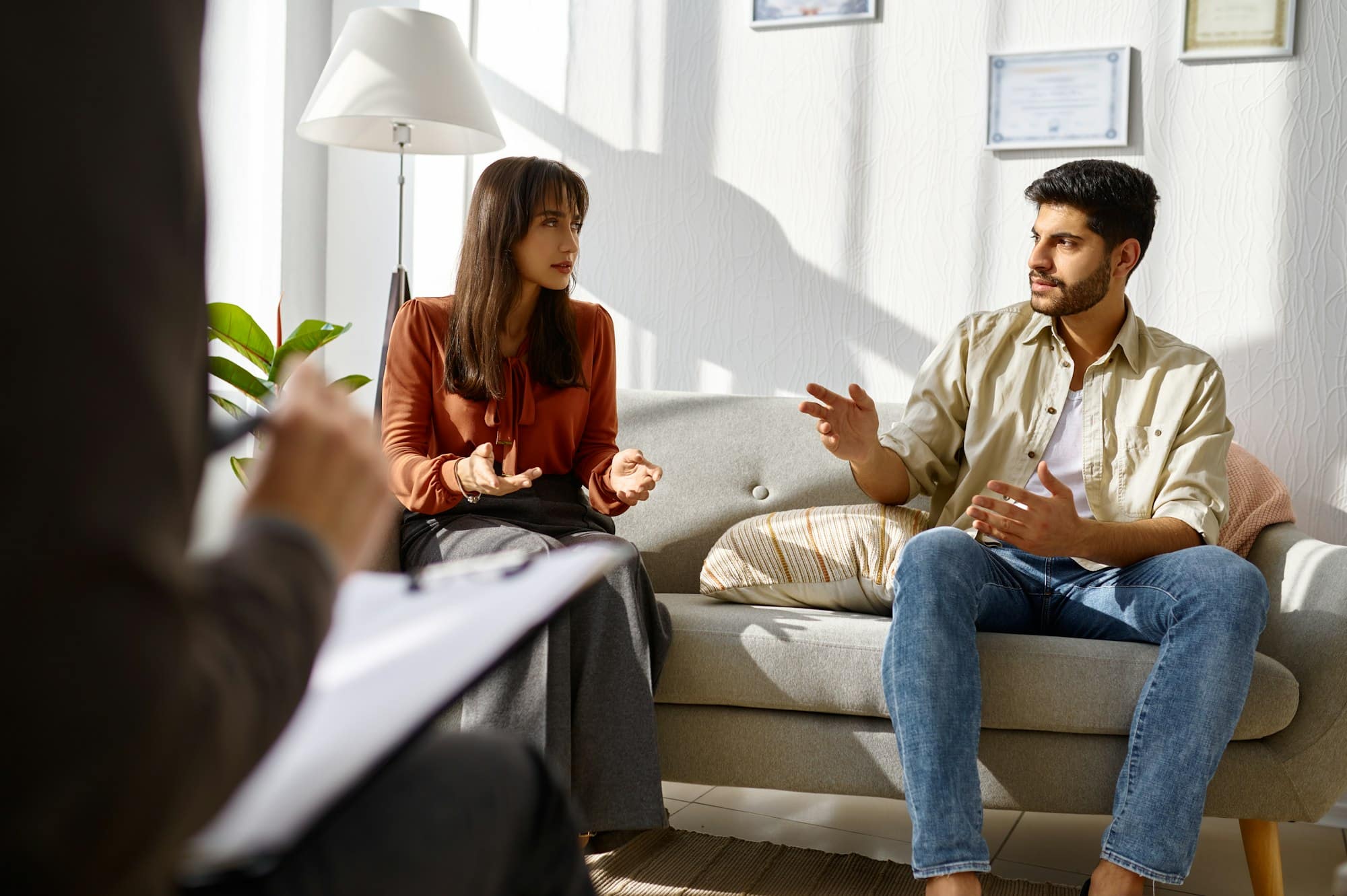 Young family couple at psychologist counseling meeting