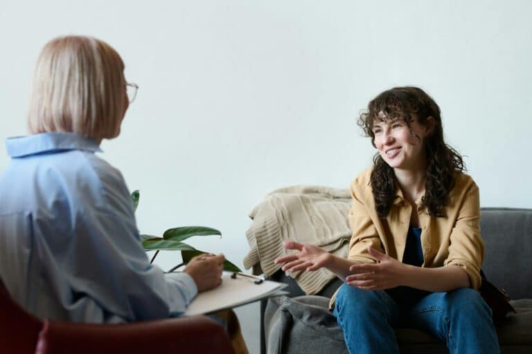 Young woman talking to therapist at session